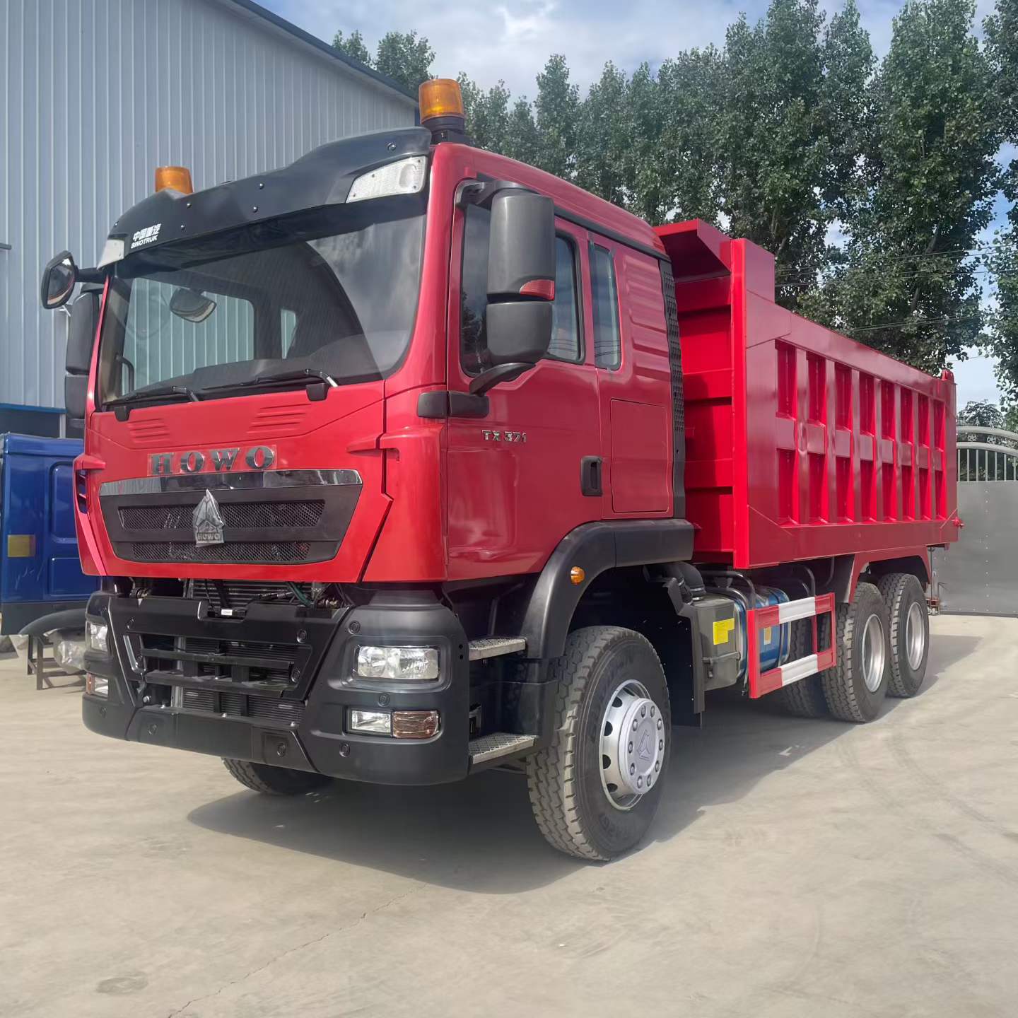 Red HOWO dump truck: front and side reference view.