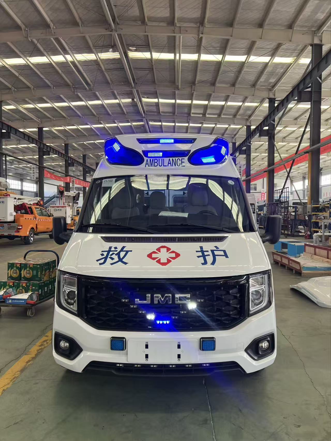 Real photograph of a JMC ambulance viewed from the front and side.